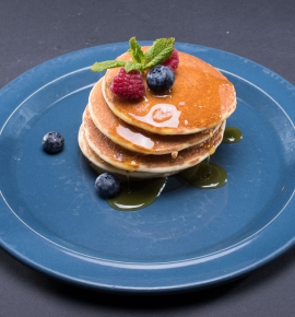 American pancakes with maple syrup and fresh berries